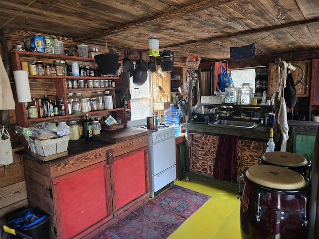 interior space with wood ceiling and a sink