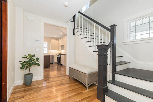 11 Rogers Rd, Kittery, ME 03904 - stairs with baseboards, wood finished floors, and plenty of natural light