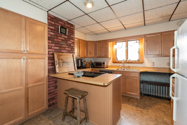 546 Main St, Westbrook, ME 04092 - kitchen featuring freestanding refrigerator, a drop ceiling, a sink, a breakfast bar area, and a peninsula