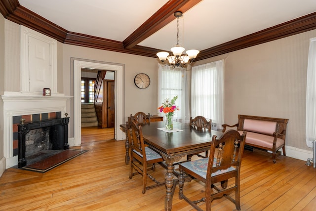 546 Main St, Westbrook, ME 04092 - dining room with ornamental molding, light wood-style flooring, a chandelier, a fireplace, and stairs