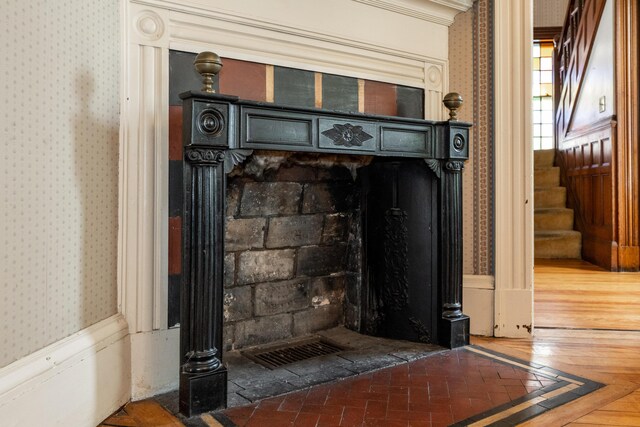 546 Main St, Westbrook, ME 04092 - detailed view of wallpapered walls, a fireplace with flush hearth, and crown molding