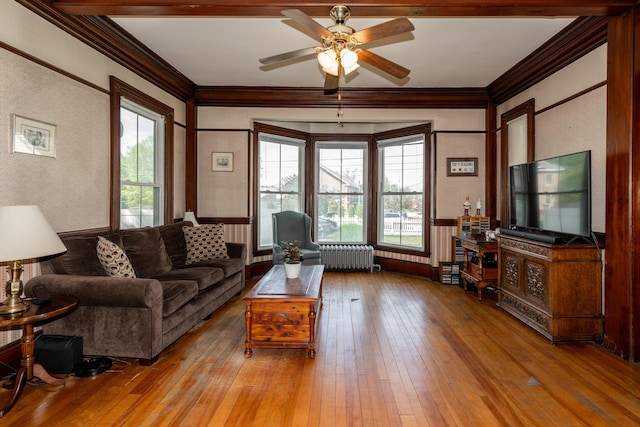 546 Main St, Westbrook, ME 04092 - living room with radiator heating unit, crown molding, ceiling fan, and hardwood / wood-style floors