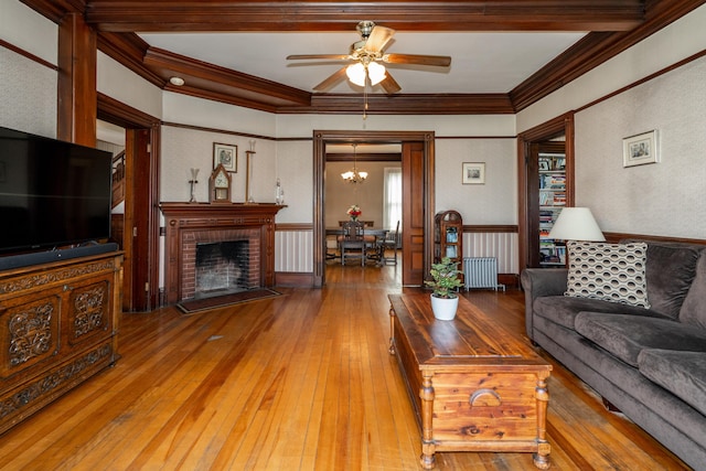 546 Main St, Westbrook, ME 04092 - living area with ornamental molding, hardwood / wood-style floors, a ceiling fan, a brick fireplace, and a chandelier