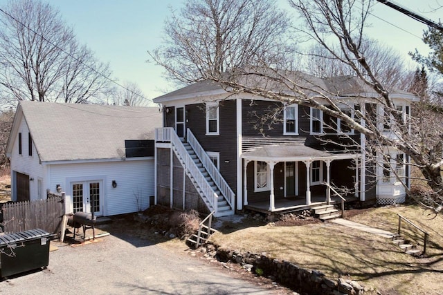 6 Naskeag Rd, Brooklin, ME 04616 - view of front facade featuring covered porch, roof with shingles, stairs, an attached garage, and french doors