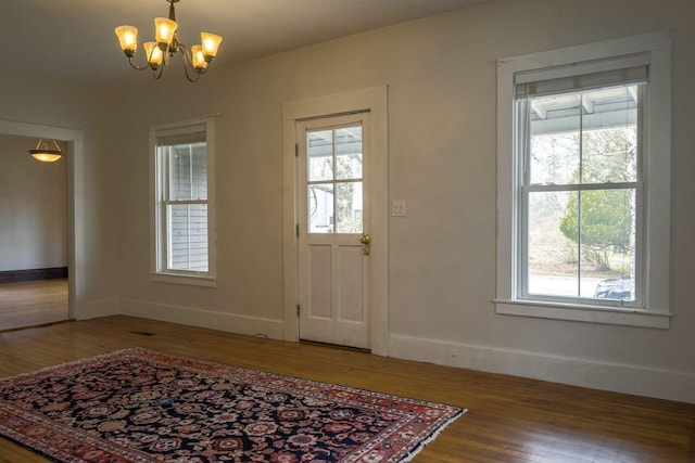 6 Naskeag Rd, Brooklin, ME 04616 - foyer entrance featuring a wealth of natural light, wood finished floors, baseboards, and a notable chandelier