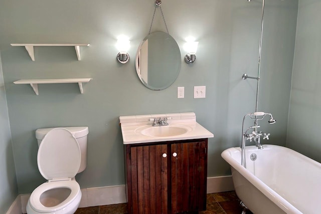 6 Naskeag Rd, Brooklin, ME 04616 - bathroom with vanity, toilet, baseboards, and a soaking tub
