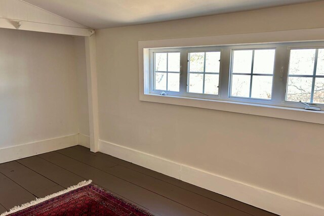 6 Naskeag Rd, Brooklin, ME 04616 - unfurnished room with lofted ceiling, baseboards, and dark wood finished floors