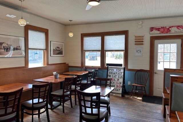 6 Naskeag Rd, Brooklin, ME 04616 - dining space with wood walls, dark wood-style flooring, and ceiling fan