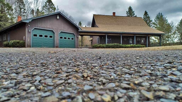 view of front facade with a chimney and an attached garage
