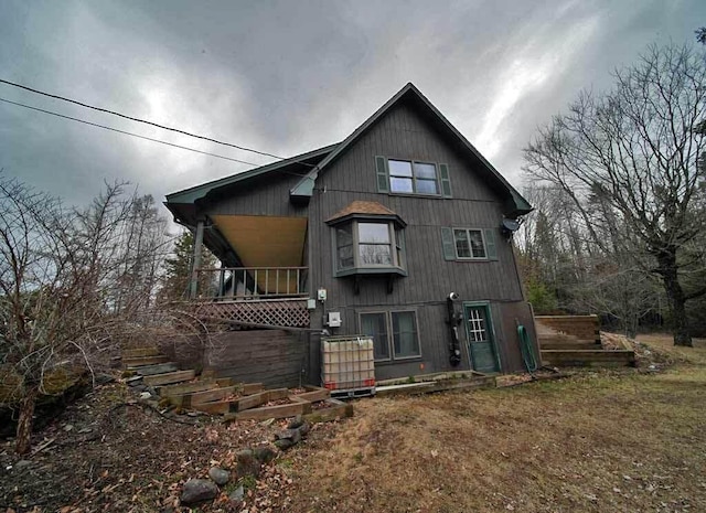 rear view of property featuring stairs