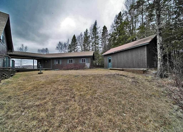 rear view of house featuring a lawn