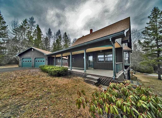 view of side of home with a chimney and a garage