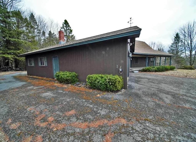 view of property exterior with a chimney