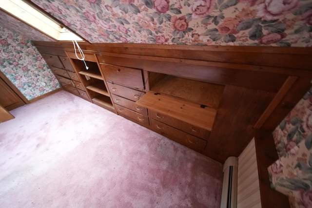 bonus room with a skylight, wallpapered walls, and a baseboard radiator