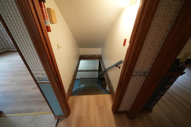 stairway with baseboards and wood finished floors