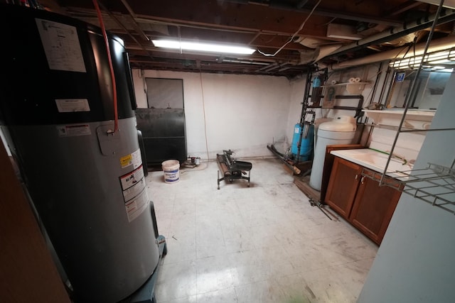 unfinished basement with water heater and light floors