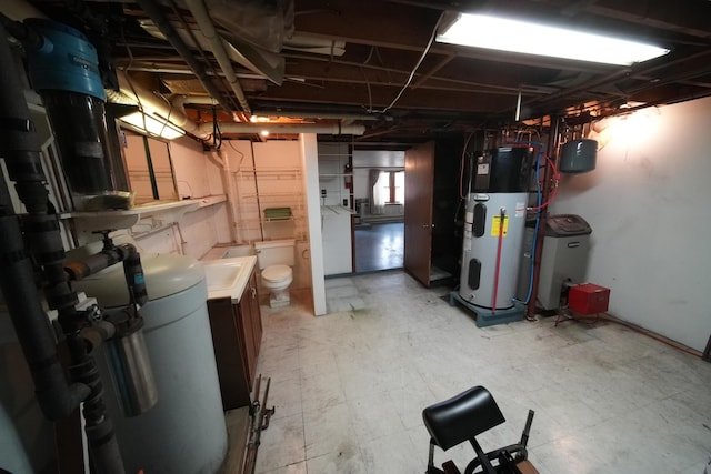 basement featuring light floors and heat pump water heater