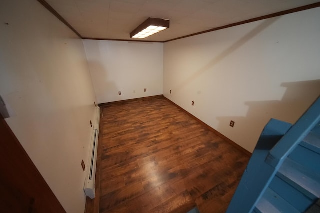 finished below grade area with baseboards, wood finished floors, and ornamental molding