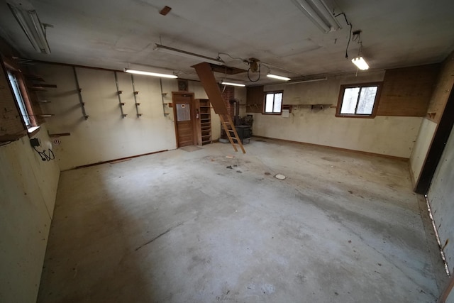 basement with electric panel and stairs