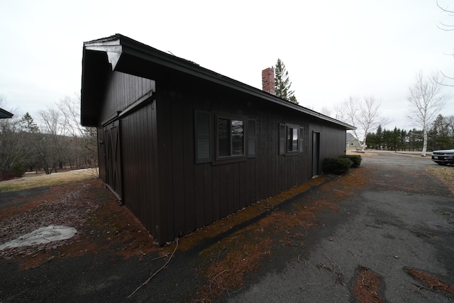 view of side of home featuring a chimney