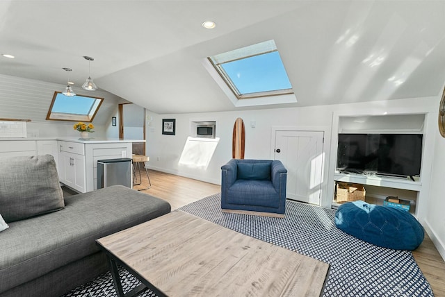living area with recessed lighting, baseboards, lofted ceiling with skylight, and light wood-type flooring