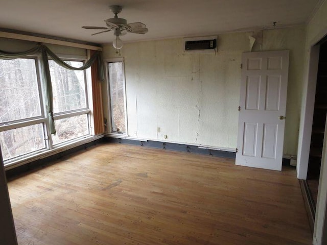 unfurnished room with ceiling fan and wood finished floors