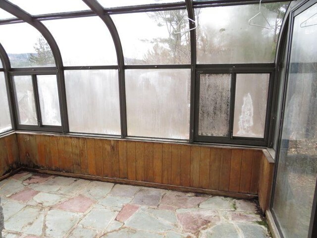 unfurnished sunroom featuring a healthy amount of sunlight