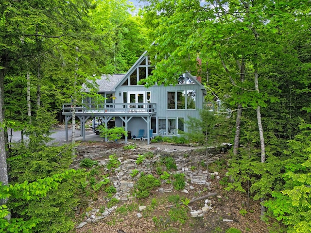 back of house featuring a wooden deck