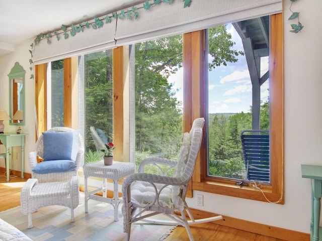 sunroom / solarium with baseboards and wood finished floors