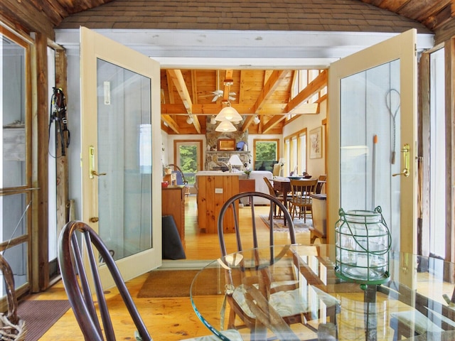 dining room with wooden ceiling, vaulted ceiling with beams, and wood finished floors