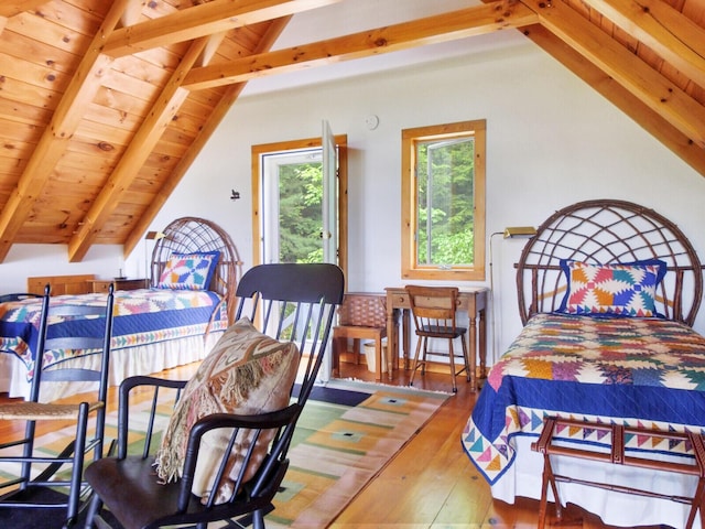 bedroom featuring lofted ceiling with beams and hardwood / wood-style flooring