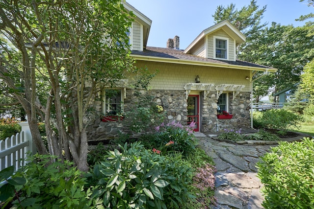 22 Porter Rd, Belfast, ME 04915 - view of front of property with stone siding, a chimney, and fence
