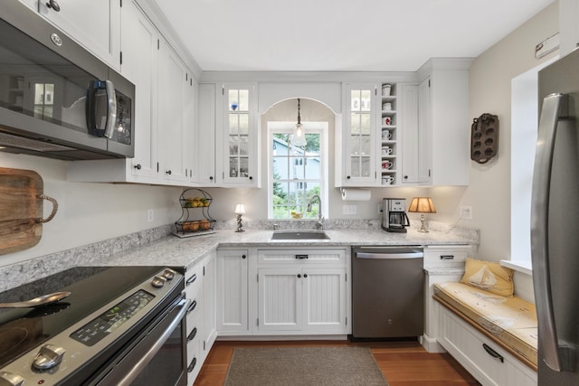 22 Porter Rd, Belfast, ME 04915 - kitchen with dark wood finished floors, appliances with stainless steel finishes, white cabinetry, and a sink