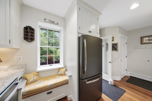 22 Porter Rd, Belfast, ME 04915 - kitchen featuring baseboard heating, wood finished floors, stainless steel appliances, light countertops, and white cabinets