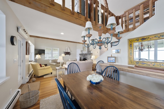 22 Porter Rd, Belfast, ME 04915 - dining space featuring baseboard heating, an inviting chandelier, wood finished floors, and recessed lighting