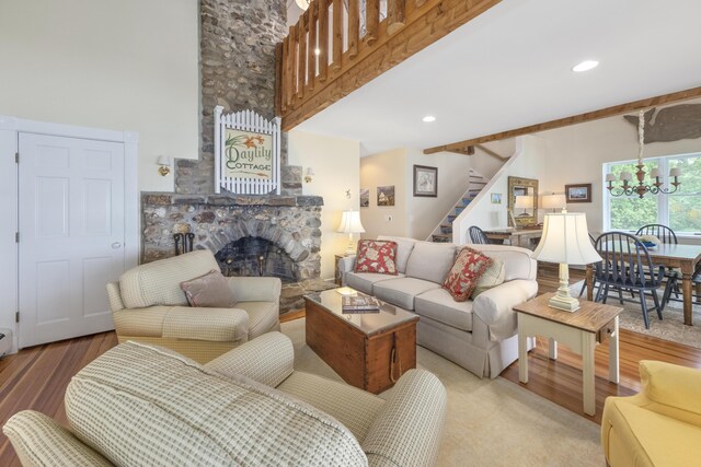22 Porter Rd, Belfast, ME 04915 - living area with recessed lighting, an inviting chandelier, wood finished floors, a fireplace, and stairs