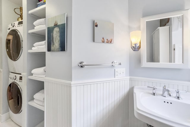 22 Porter Rd, Belfast, ME 04915 - bathroom with stacked washer and dryer, a wainscoted wall, and a sink