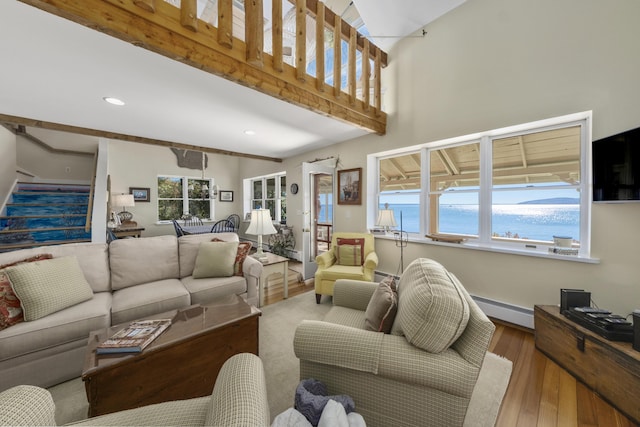 22 Porter Rd, Belfast, ME 04915 - living area featuring baseboard heating, recessed lighting, wood finished floors, and stairway