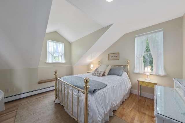 22 Porter Rd, Belfast, ME 04915 - bedroom featuring a baseboard radiator, vaulted ceiling, wood finished floors, and baseboards