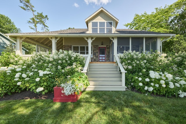 22 Porter Rd, Belfast, ME 04915 - view of front of home featuring a sunroom, stone siding, and a front yard