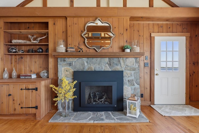 1 Moore Ln, Biddeford, ME 04005 - living room with light wood-type flooring, a stone fireplace, and wood walls
