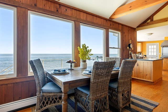 1 Moore Ln, Biddeford, ME 04005 - dining area featuring a baseboard heating unit, light wood-style floors, a water view, and wooden walls