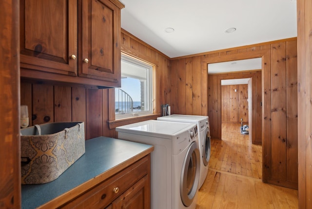 1 Moore Ln, Biddeford, ME 04005 - laundry area featuring cabinet space, light wood finished floors, separate washer and dryer, and wood walls