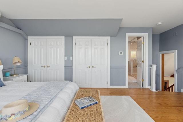 1 Moore Ln, Biddeford, ME 04005 - bedroom featuring multiple closets, wood finished floors, and a wainscoted wall