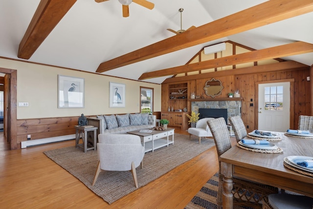 1 Moore Ln, Biddeford, ME 04005 - living room with baseboard heating, light wood-style floors, a ceiling fan, plenty of natural light, and wood walls