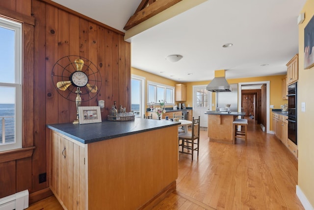 1 Moore Ln, Biddeford, ME 04005 - kitchen with island range hood, a baseboard heating unit, a peninsula, a kitchen bar, and light wood-style floors