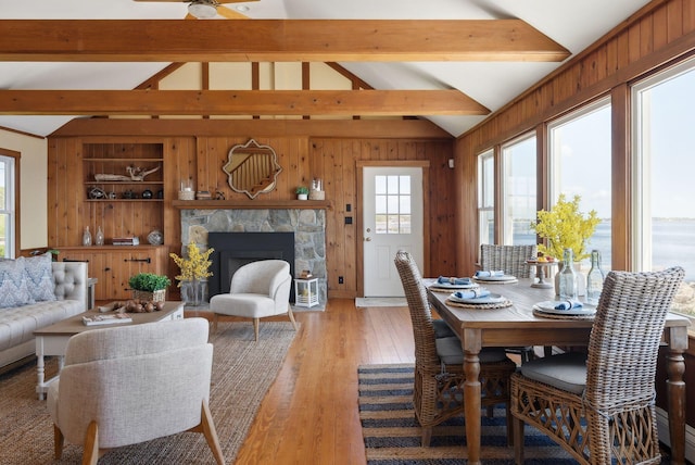 1 Moore Ln, Biddeford, ME 04005 - dining space with light wood-style flooring, wooden walls, a fireplace, and ceiling fan