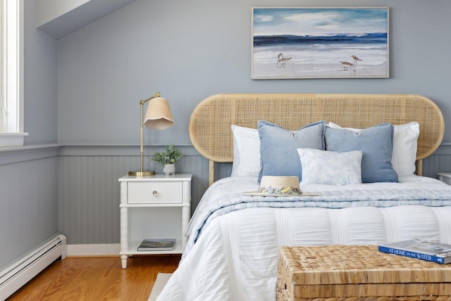1 Moore Ln, Biddeford, ME 04005 - bedroom with baseboard heating, wood finished floors, and wainscoting