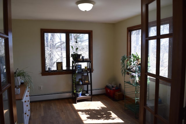 entrance foyer with a baseboard heating unit and wood finished floors