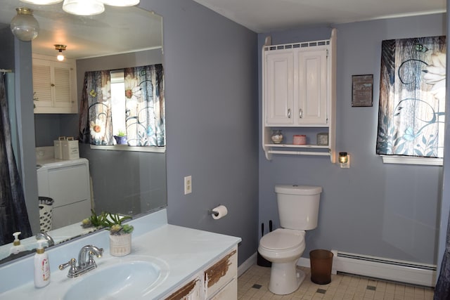 bathroom with independent washer and dryer, baseboard heating, vanity, baseboards, and toilet